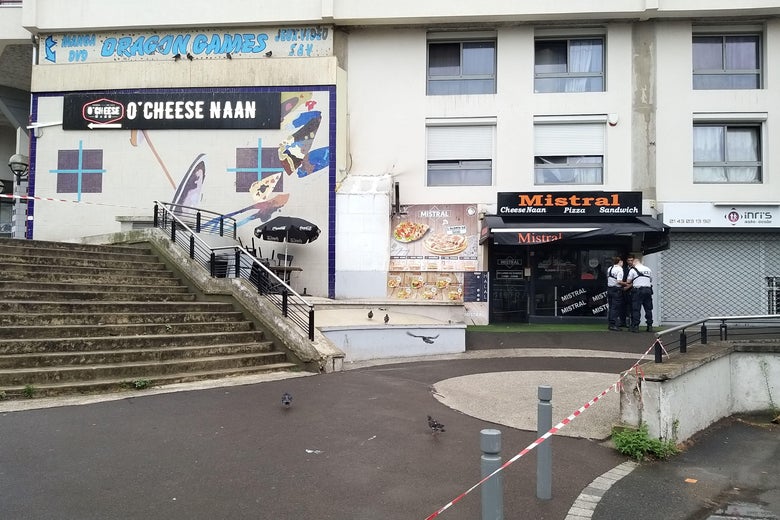 Policemen stand in front of the restaurant.