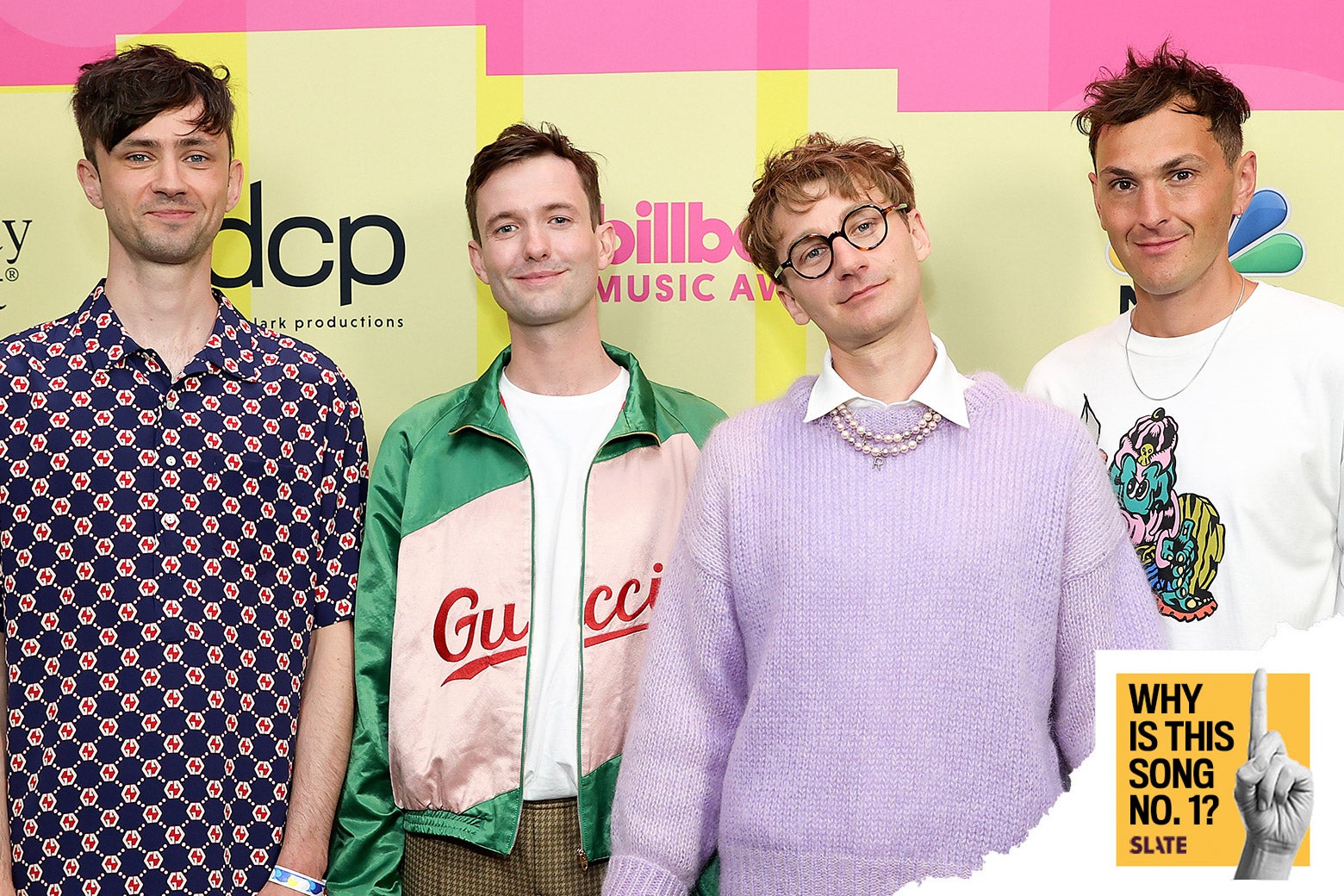 The four members of the band Glass Animals in front of a Billboard Music Awards step-and-repeat.