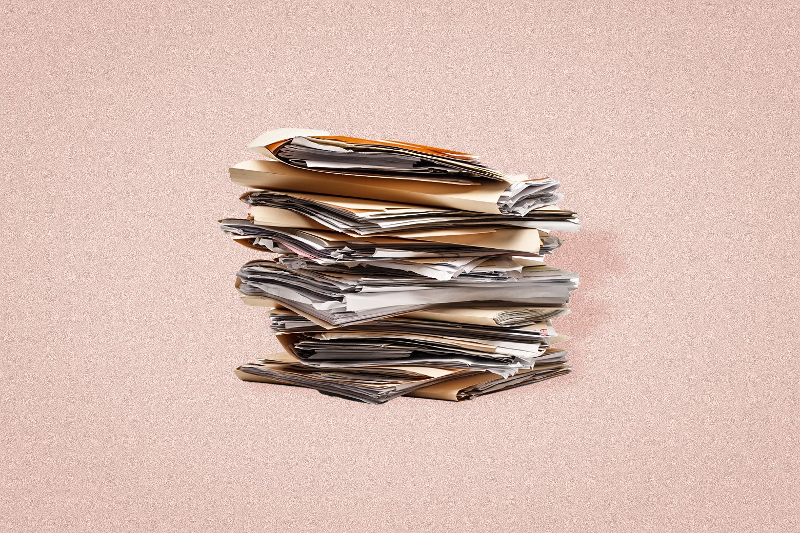 An overwhelming stack of bulging disorganized file folders. 