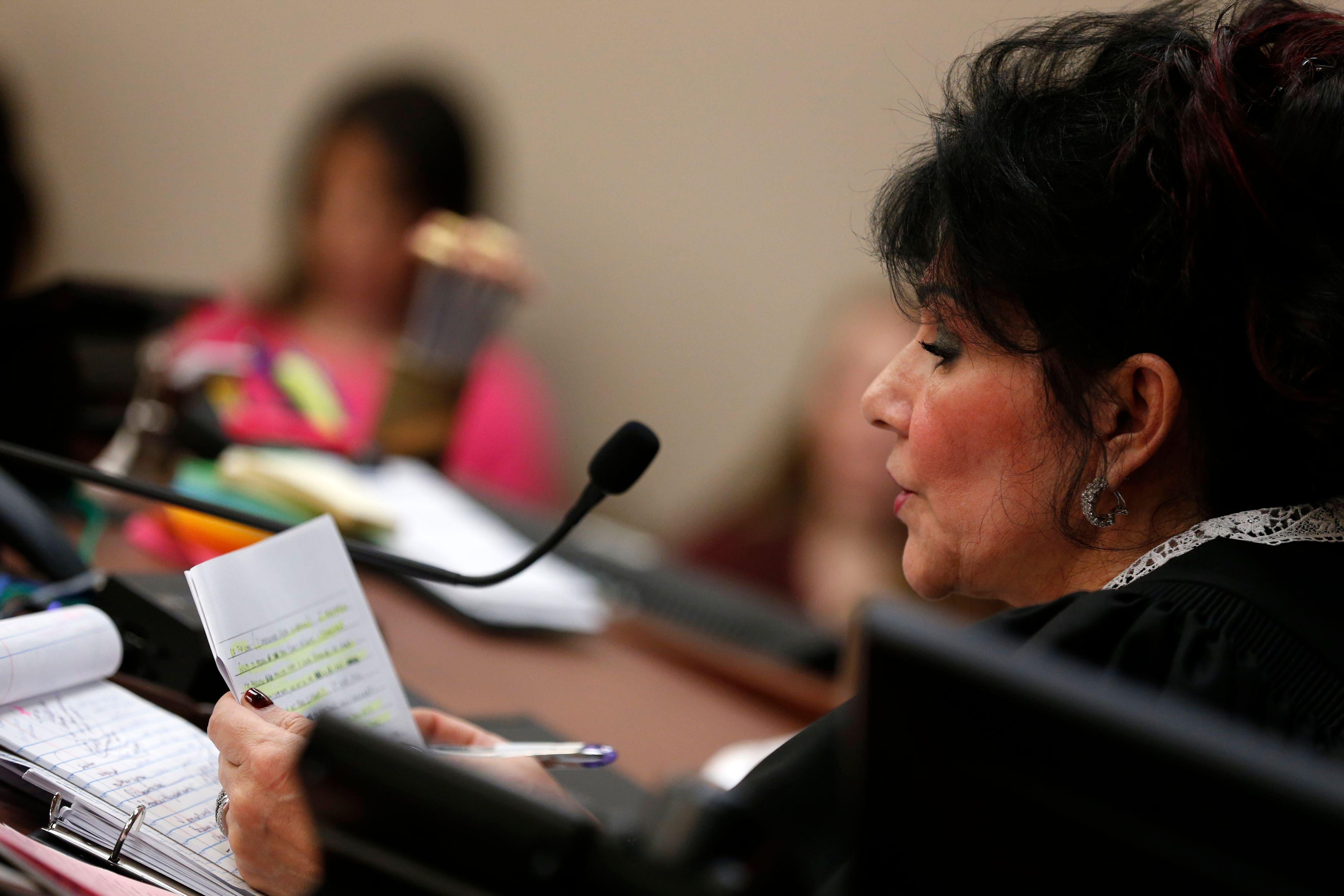Judge Rosemarie Aquilina reads a statement from Larry Nassar during the sentencing phase in Ingham County Circuit Court on Wednesday in Lansing, Michigan.