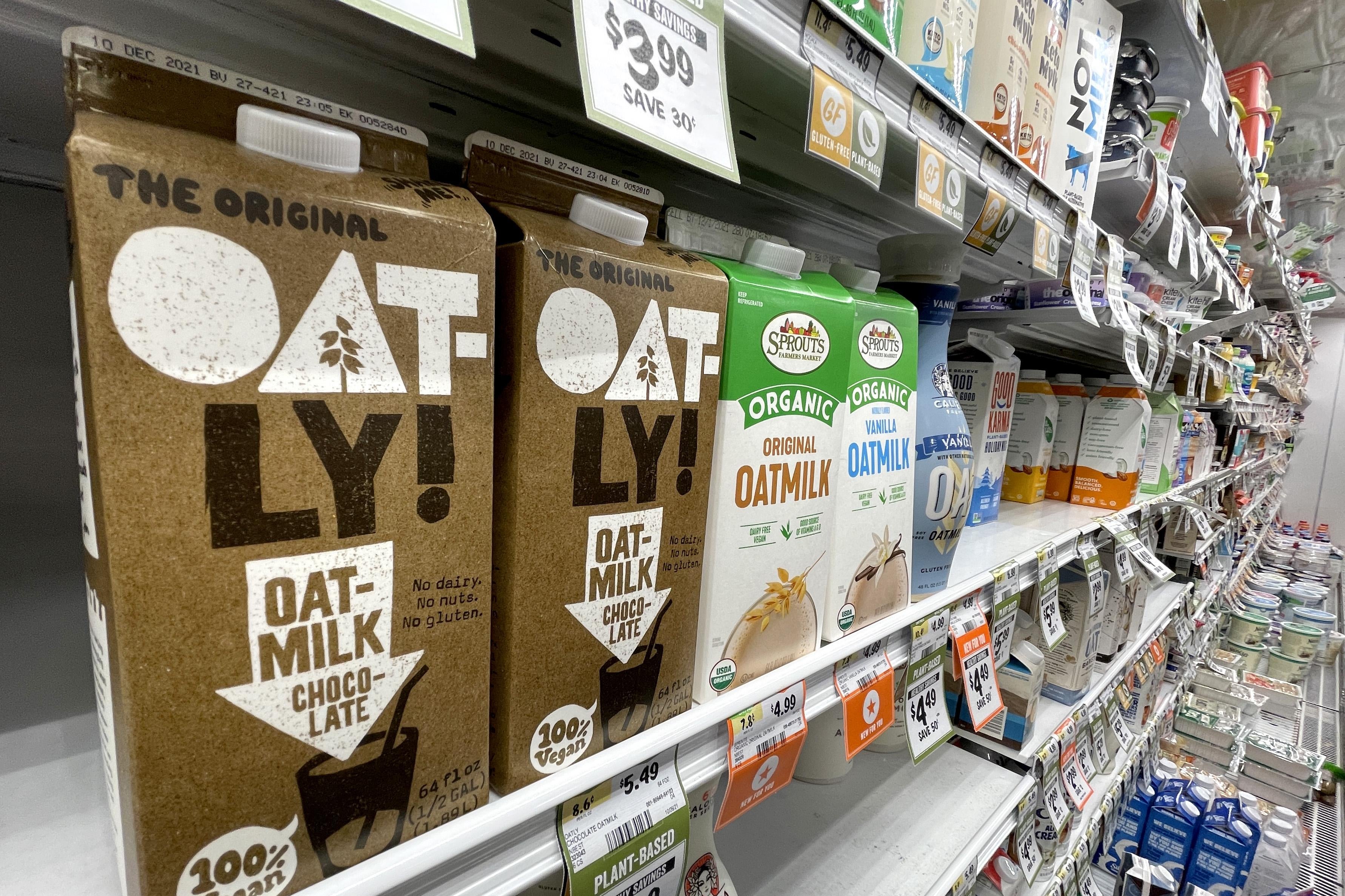 Cartons of oat milk on a supermarket shelf