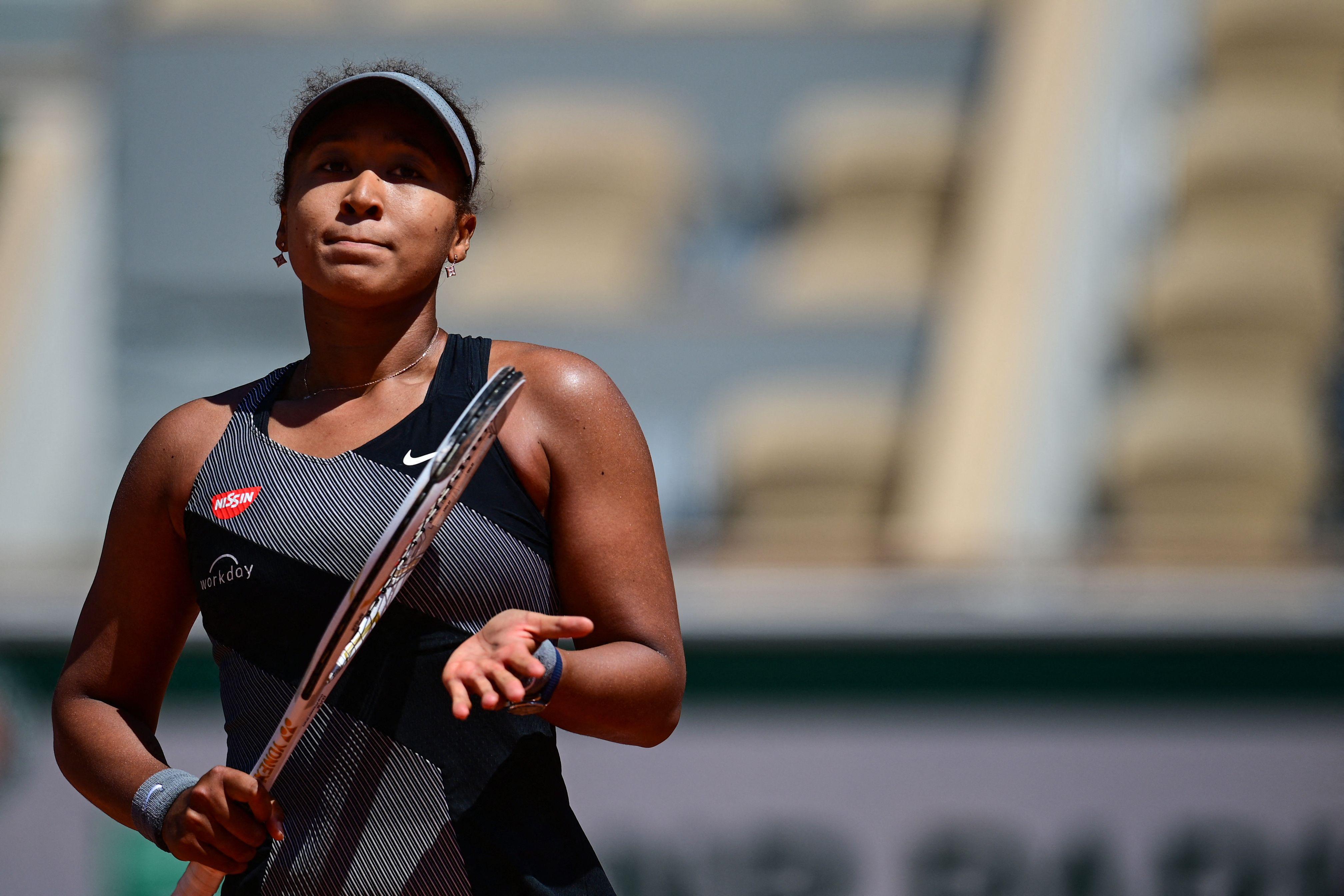 Japan's Naomi Osaka celebrates after winning against Romania's Patricia Maria Tig during their women's singles first round tennis match on Day 1 of The Roland Garros 2021 French Open tennis tournament in Paris on May 30, 2021.