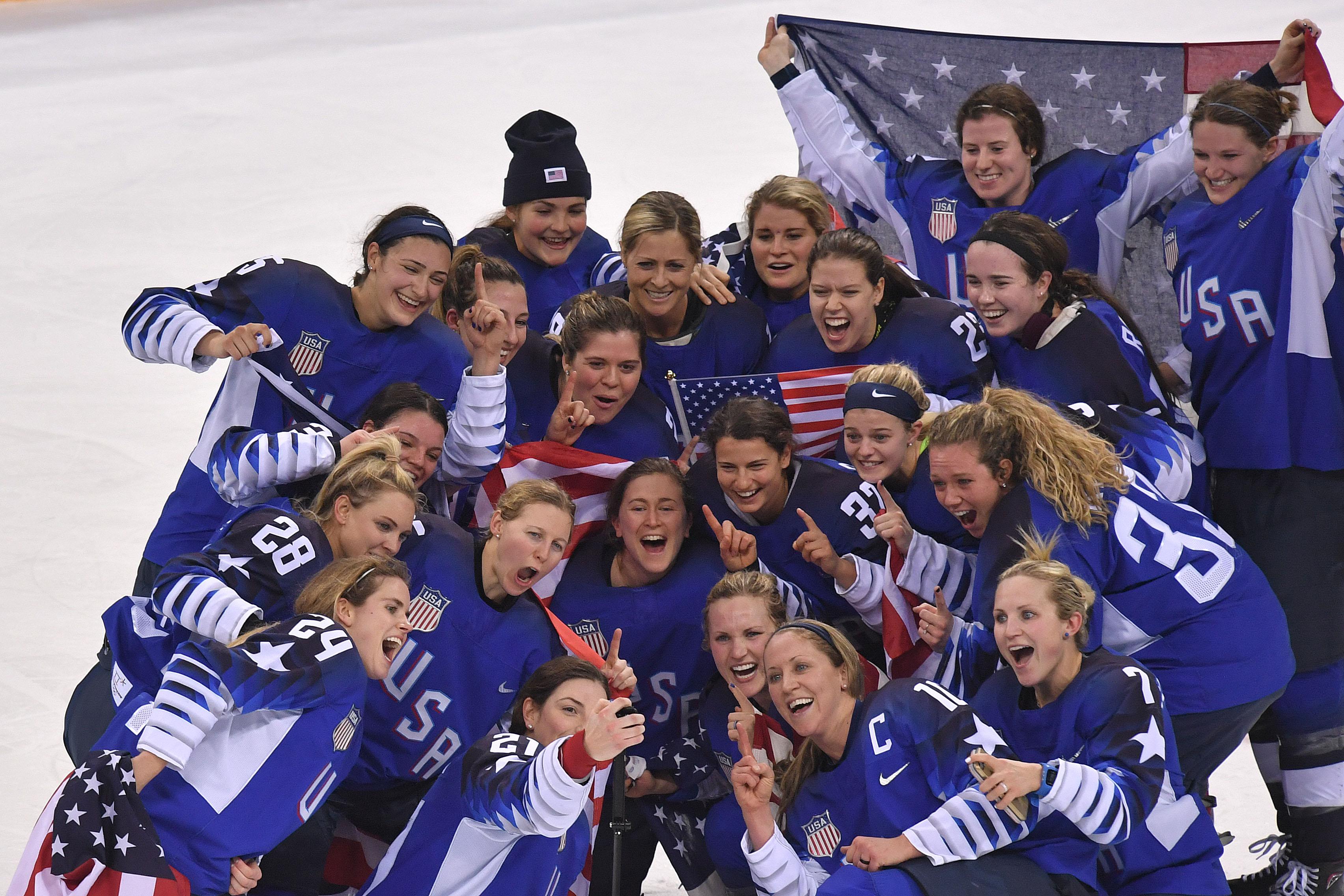 TOPSHOT - USA's Hilary Knight (21) takes a selfie with her team as they celebrate their win after a penalty shootout in the women's gold medal ice hockey match between Canada and the US during the Pyeongchang 2018 Winter Olympic Games at the Gangneung Hockey Centre in Gangneung on February 22, 2018.  / AFP PHOTO / Ed JONES        (Photo credit should read ED JONES/AFP/Getty Images)