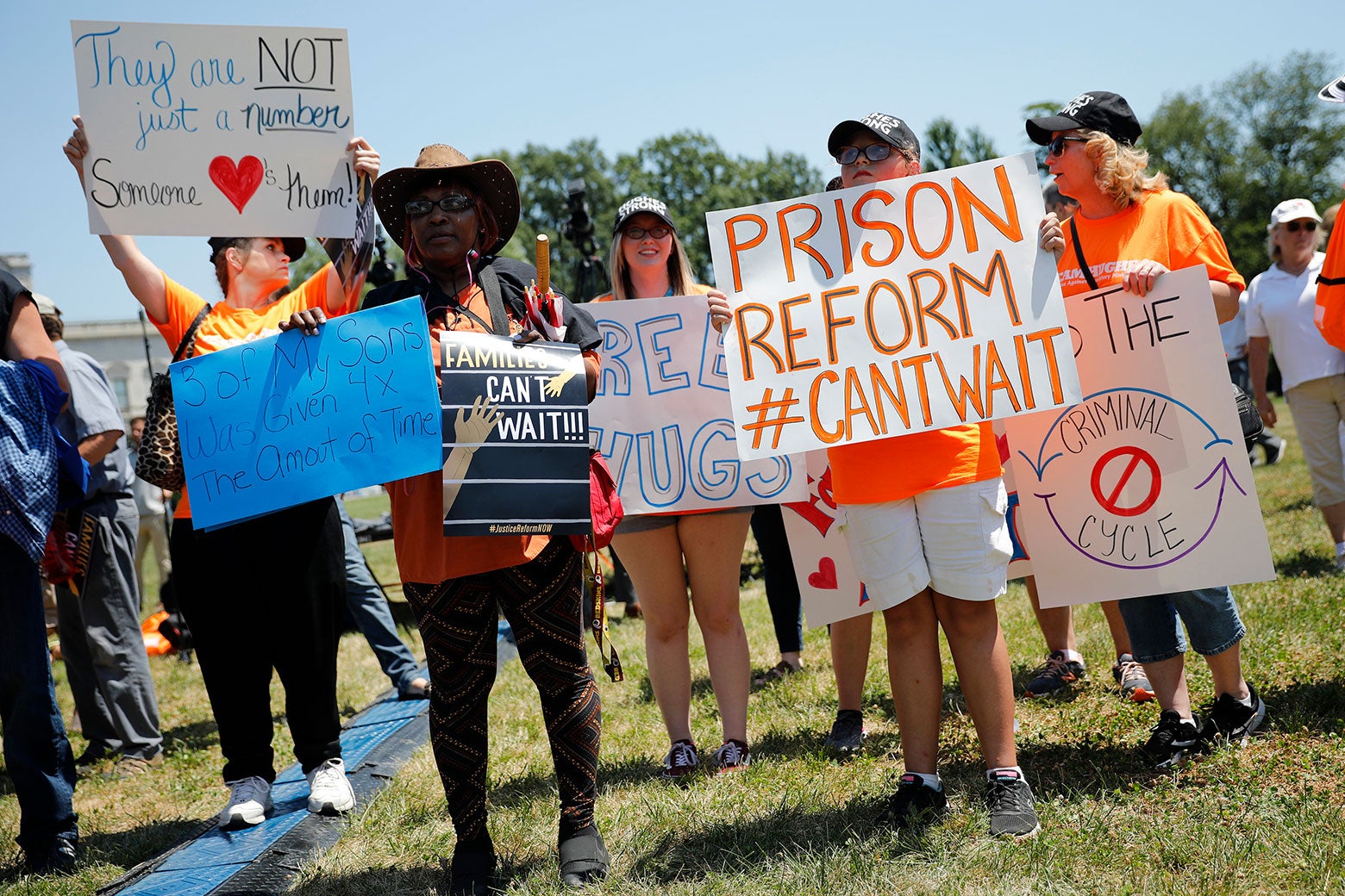 Protesters hold signs during a rally calling for criminal justice reform.