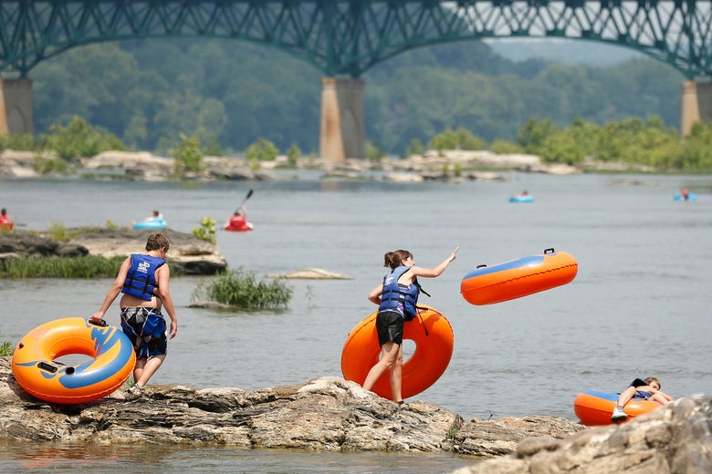 A woman hurls an inner tube into the Potomac River in Harpers Ferry, Virginia.