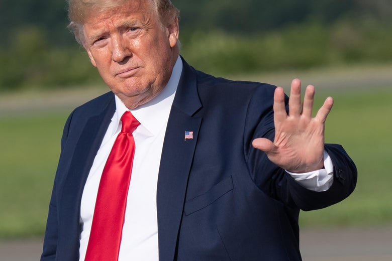 Donald Trump at Morristown Municipal Airport in Morristown, New Jersey, on Aug. 9. He is putting his hand up as if to stop something.