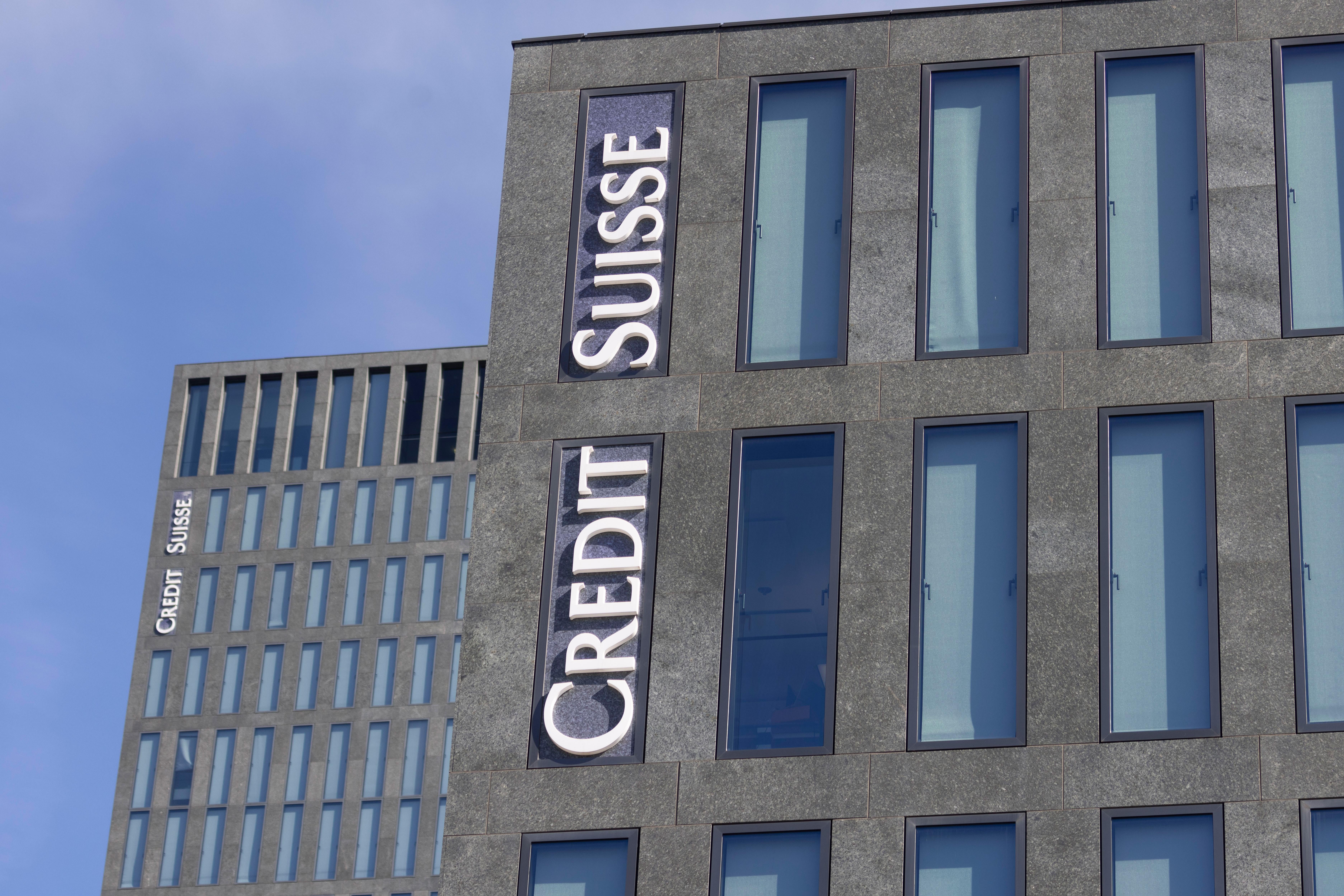 The Credit Suisse logo is displayed on a tall concrete building that has several rectangular windows.