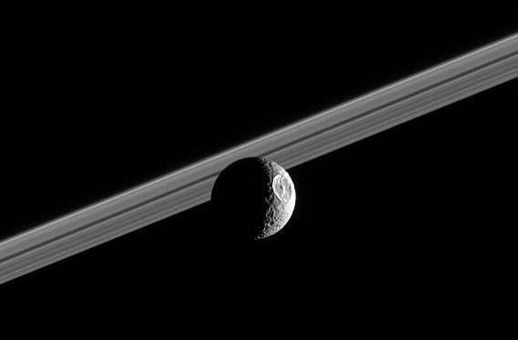 Saturn's moon Mimas, with the rings in the background.