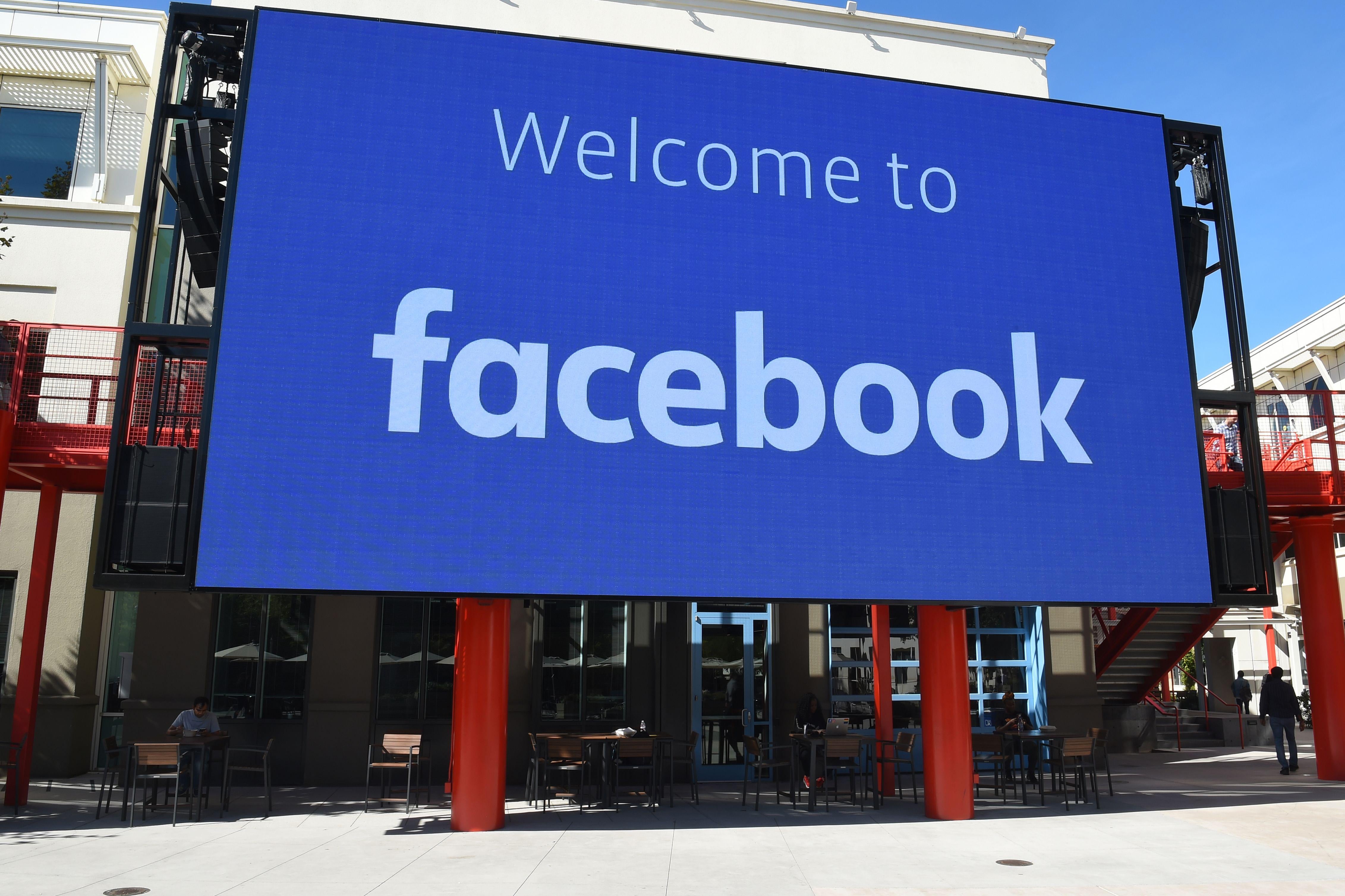 A large blue sign reads "Welcome to Facebook."