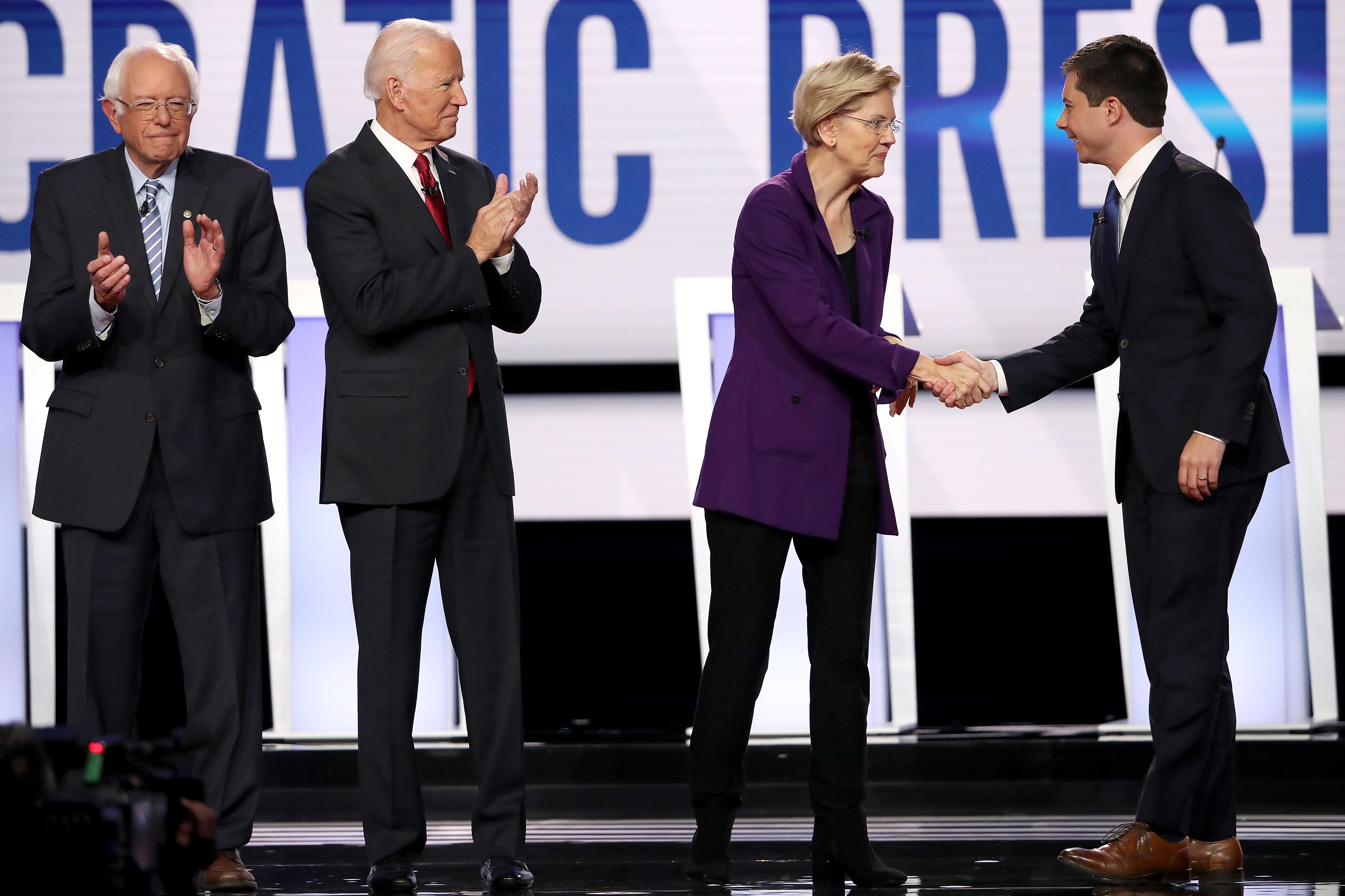 Democratic presidential candidates shake hands on stage before a presidential debate on Oct. 15, 2019 in Westerville, Ohio.