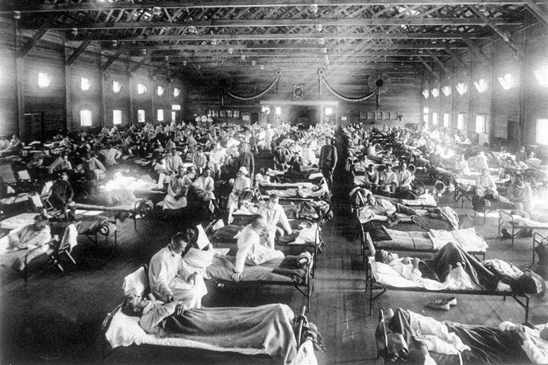 A black-and-white photo shows patients in lines of beds.