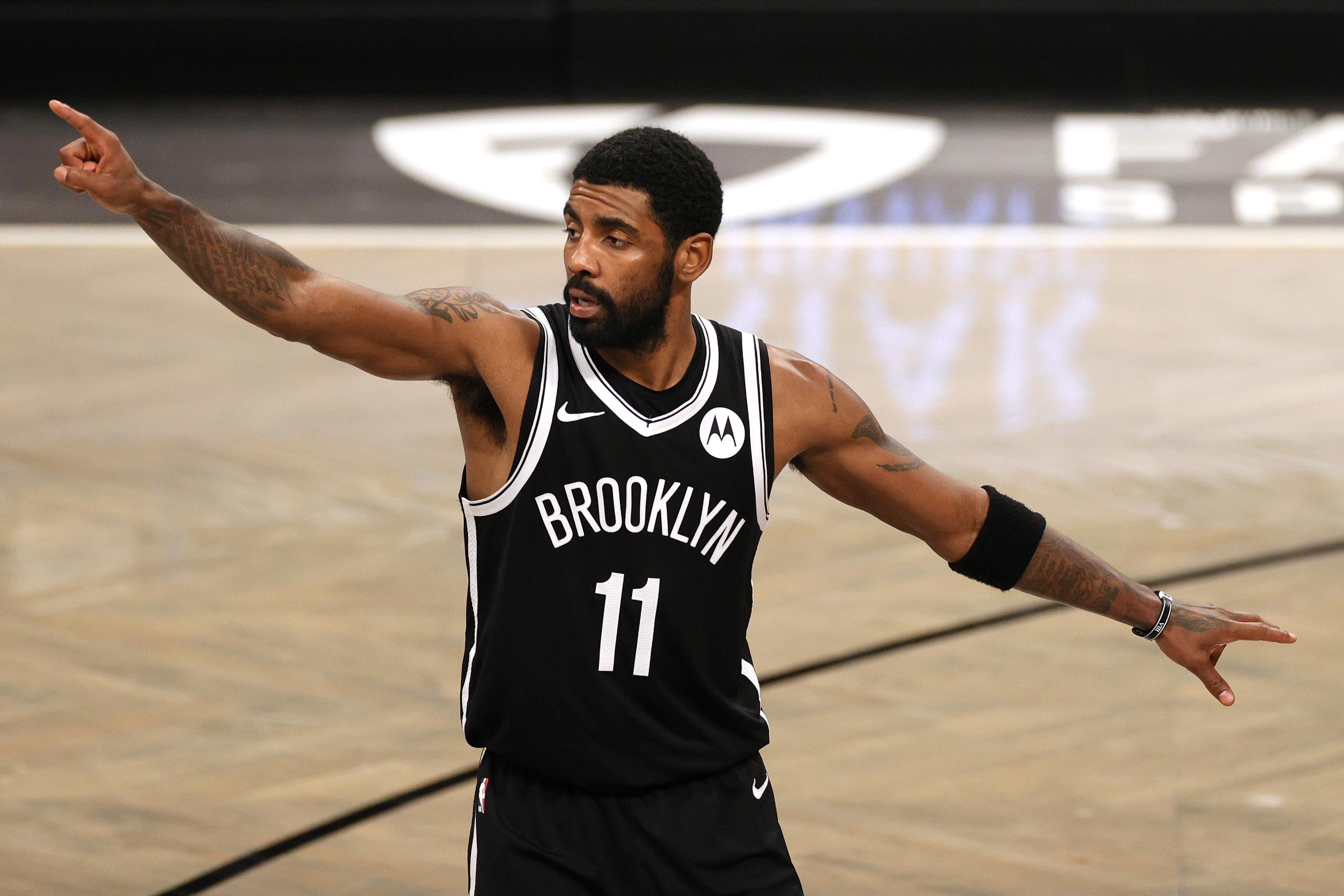 Kyrie Irving of the Brooklyn Nets points during an NBA game.