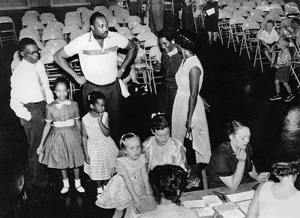Two black parents wait in line to enroll their children in the first grade at a previously all-white city school in Nashville, August 27, 1957. 