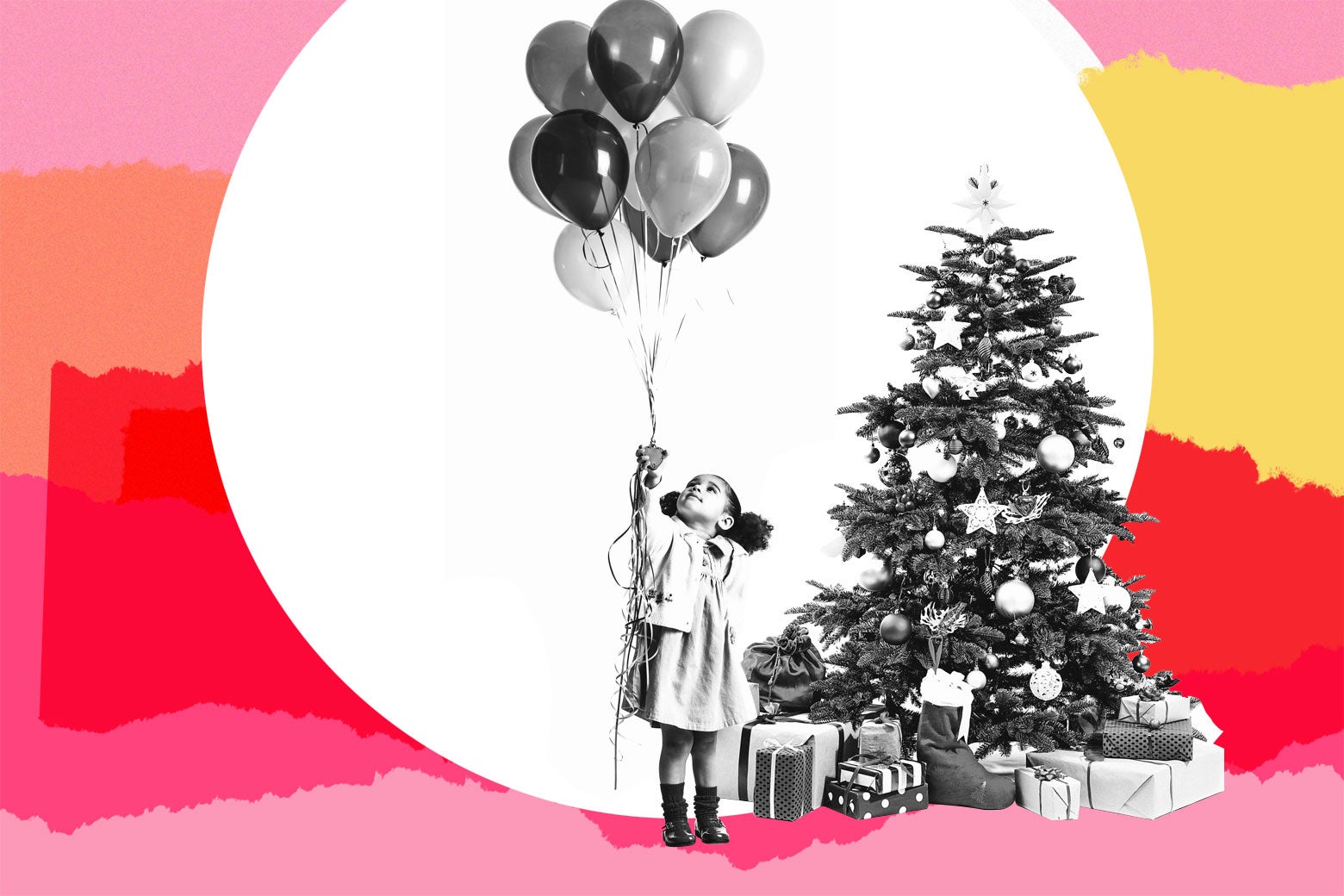 A child holding birthday balloons next to a Christmas tree.
