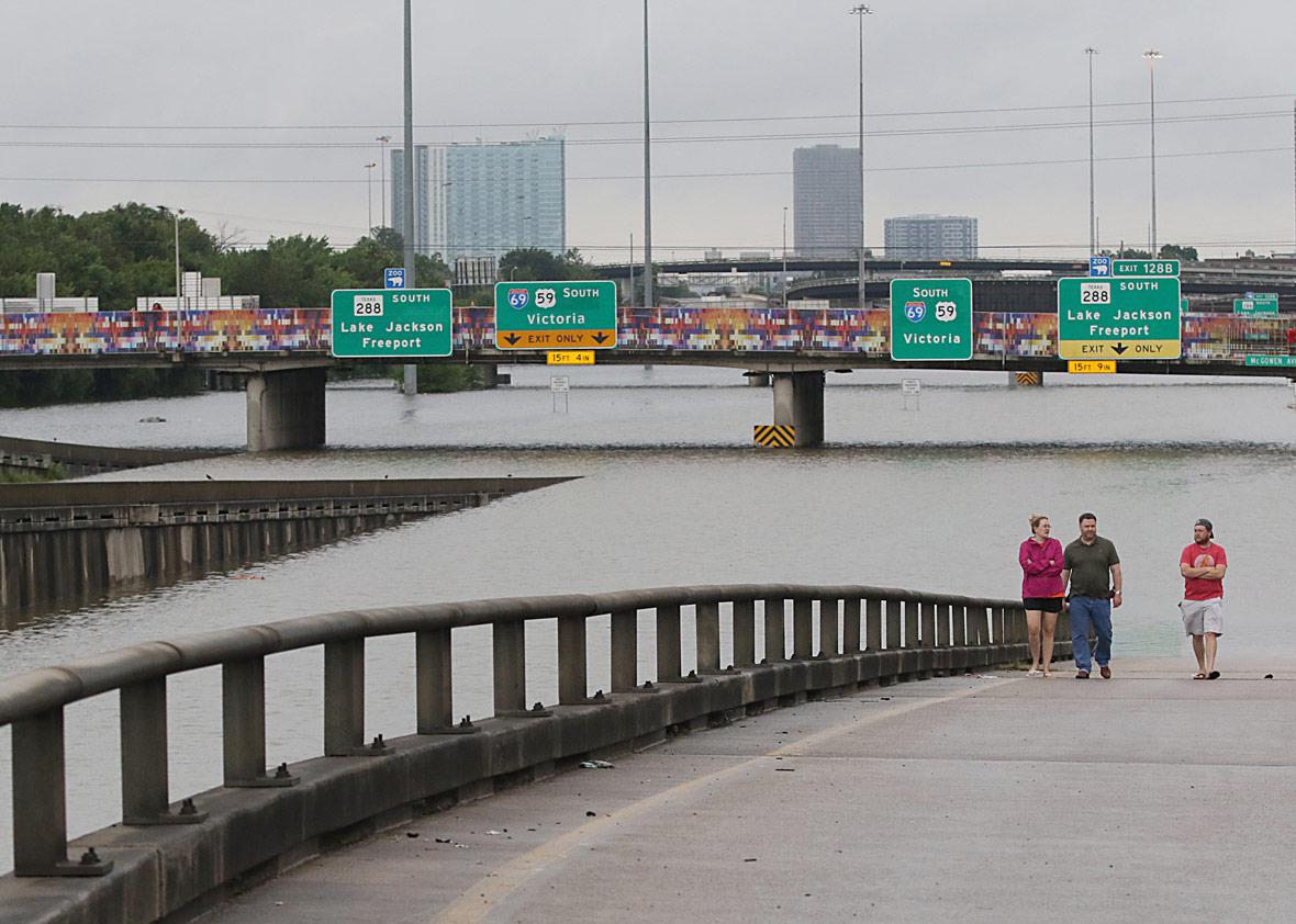 People view the flooded highways in Houston on August 27, 2017 