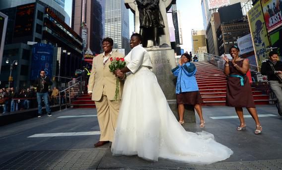Chris, right, and Renee Wiley pose for a wedding photo on Times Square in New York.