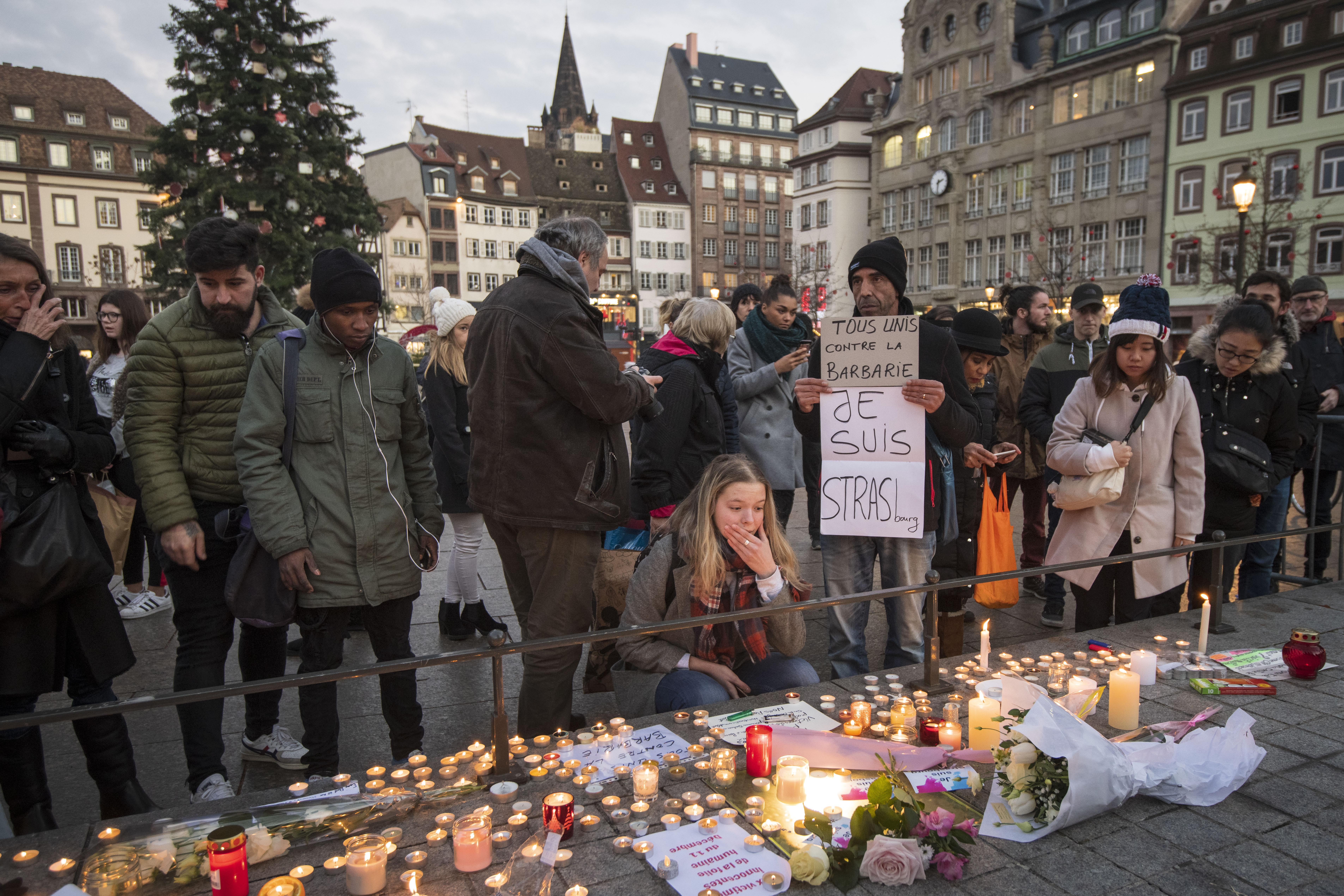 Mourners leave candles in a square in Strasbourg.