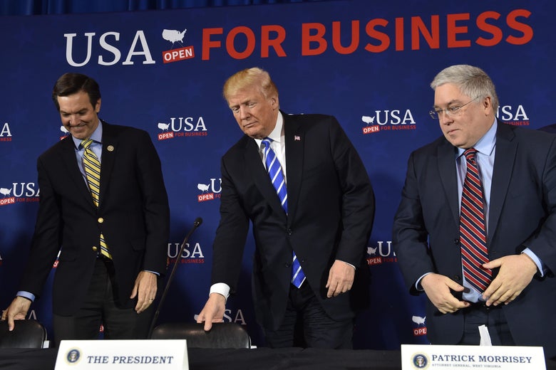 US President Donald Trump(C) arrives for a round table discussion on tax reform, at White Sulpher Springs Civic Center in White Sulpher Springs,West Virginia on April 5, 2018.
Shown to his left is Rep. Evan Jenkins, and (R)West Virginia Attorney General Patrick Morrissey. / AFP PHOTO / Nicholas Kamm (Photo credit should read NICHOLAS KAMM/AFP/Getty Images)