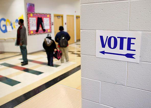 A sign directs voters to the gymnasium at the Martin Luther King elementary school for the U.S. presidential election on November 6, 2012 in Milwaukee, Wisconsin. 