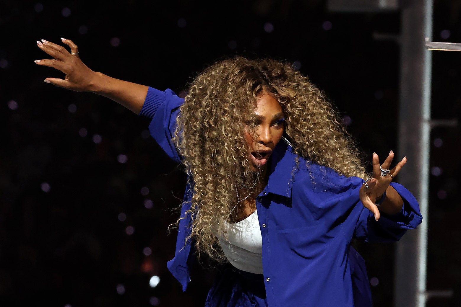 Serena Williams dancing, arms out.