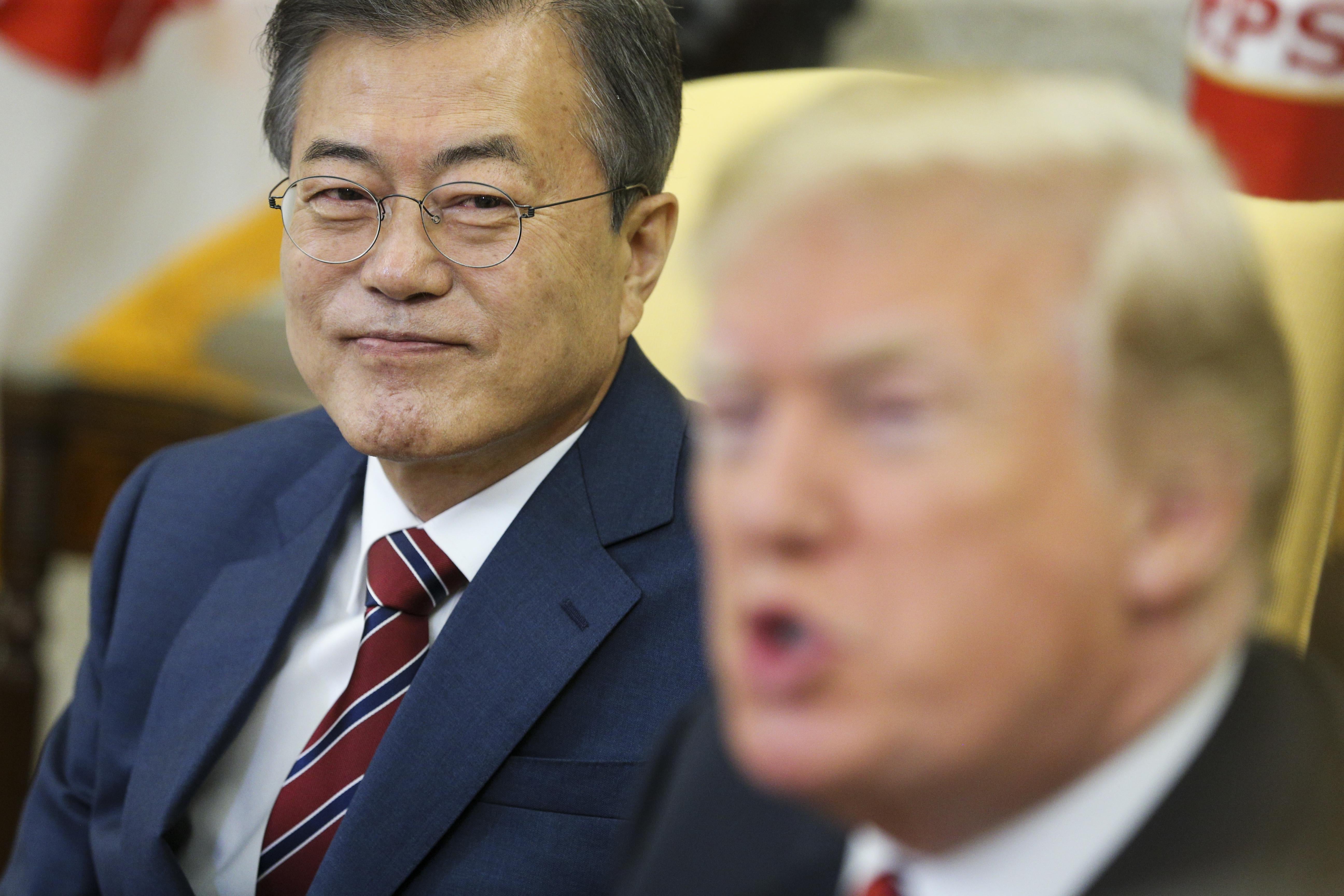 Moon Jae-in straing intently from the side while President Donald Trump speaks.