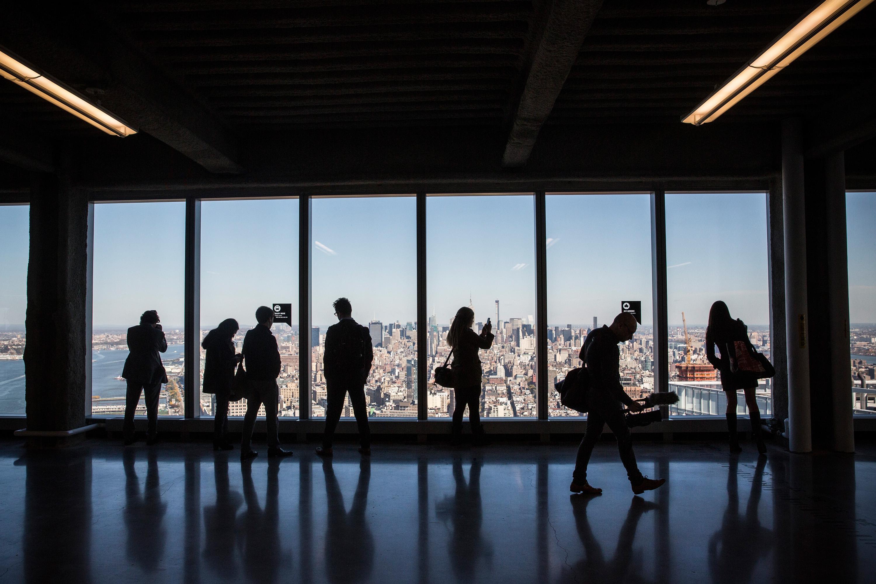 Members of the media explore a model office, used to exhibit what a business space could look like on the 63rd floor of  One World Trade Center, which opens for business today, on November 3, 2014 in New York City.