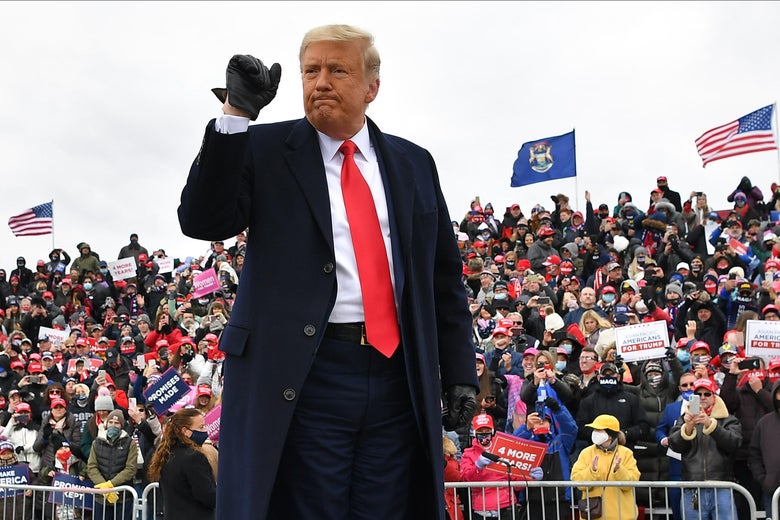 President Donald Trump gestures onstage at a rally at Oakland County International Airport, on October 30, 2020, in Waterford Township, Michigan. 