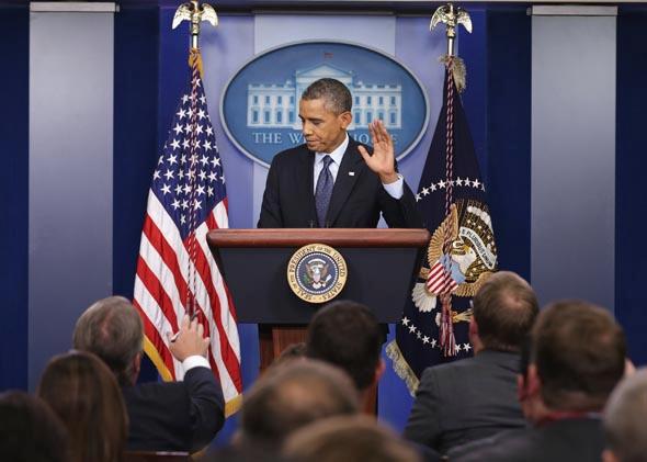 U.S. President Barack Obama waves at the conclusion of a press conference in the Brady Press Briefing Room of the White House on October 8, 2013 in Washington, DC. 