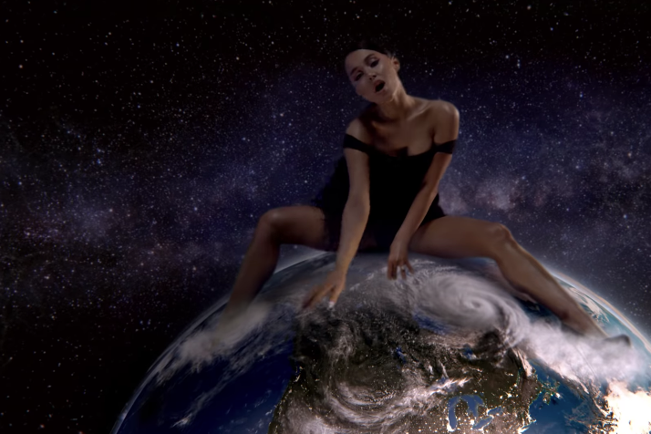 Ariana Grande straddles planet Earth.
