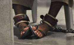 A shackled prisoner at Guantanamo Bay. 