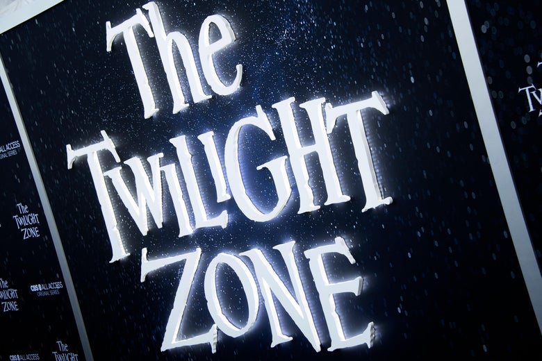 A sign on the red carpet at the premiere of the Twilight Zone displays the show's original logo.