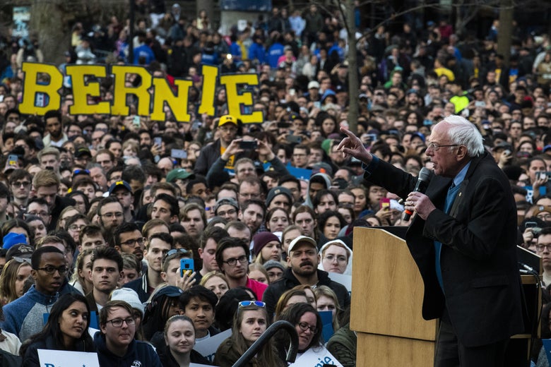 Bernie Sanders giving a speech to a large crowd.