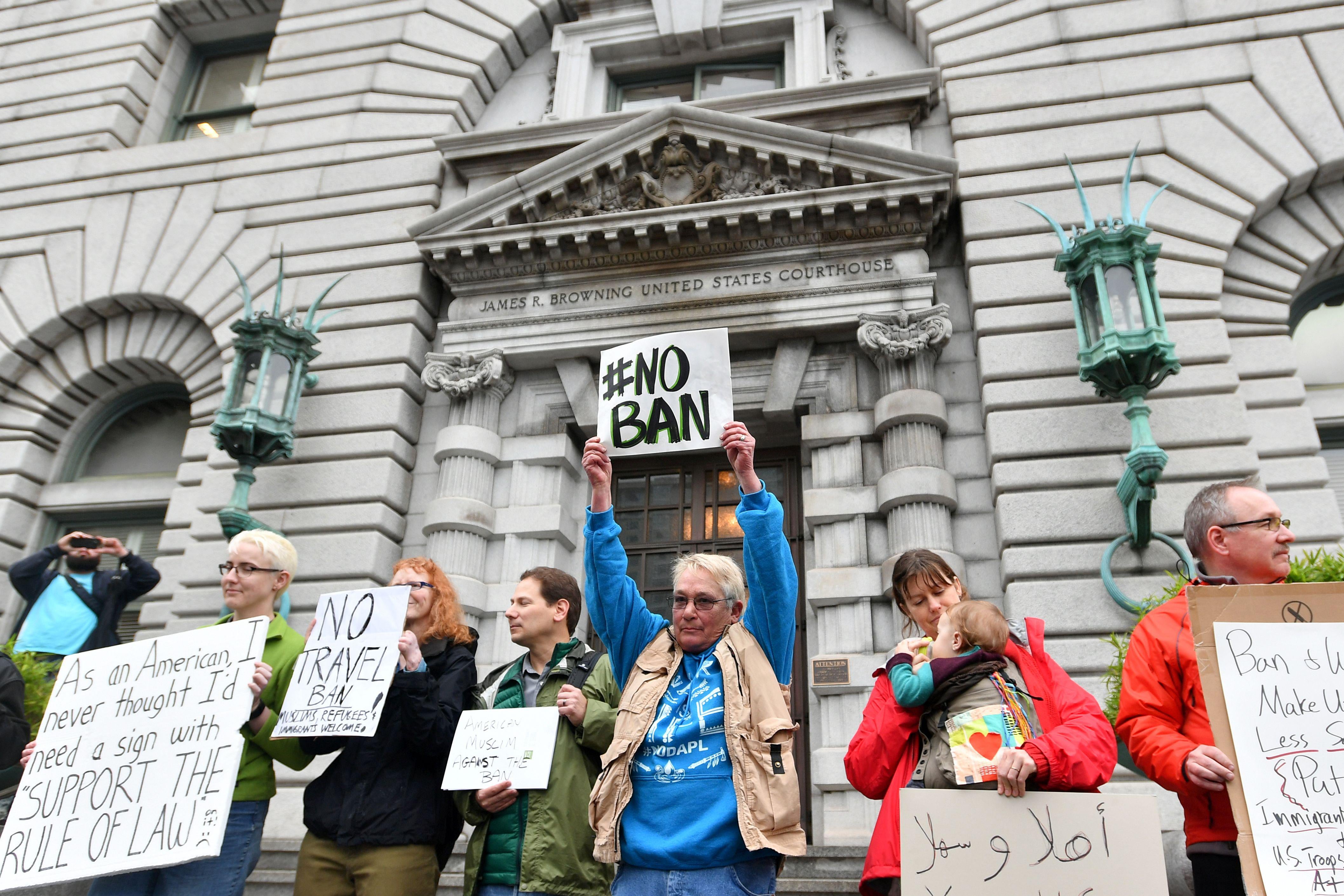 Protesters stand in front of the United States Court of Appeals for the Ninth Circuit in San Francisco, California on February 7, 2017. 
A federal appeals court heard arguments on Tuesday on whether to lift a nationwide suspension of President Donald Trump's travel ban targeting citizens of seven Muslim-majority countries. / AFP / Josh Edelson        (Photo credit should read JOSH EDELSON/AFP/Getty Images)