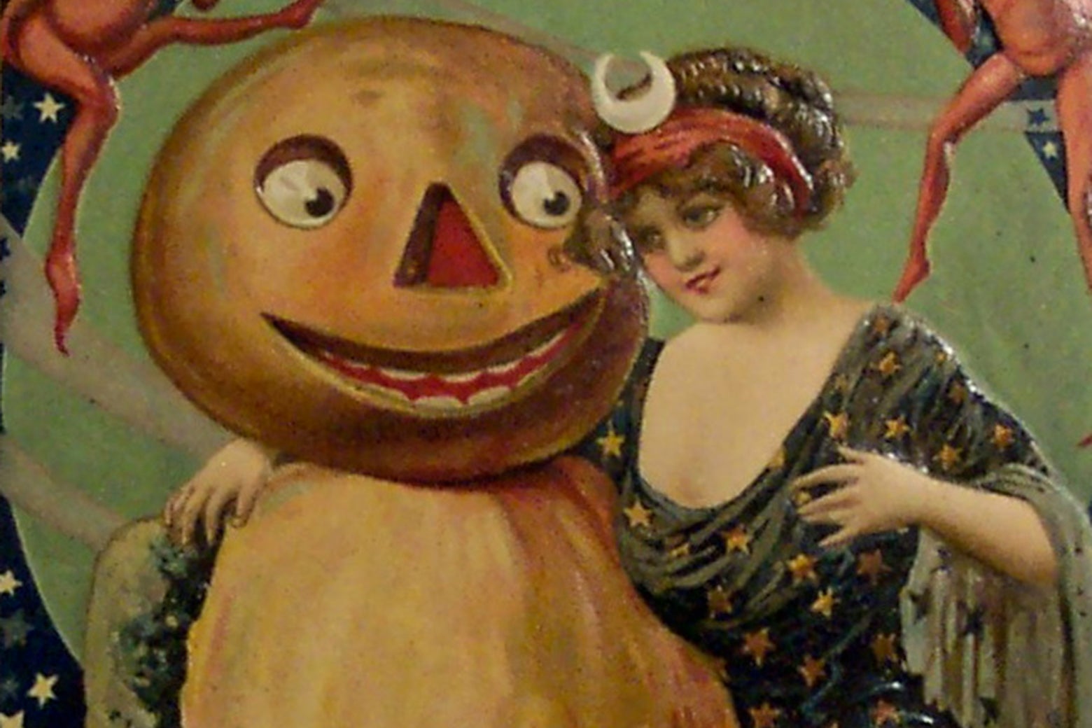 A horrible looking pumpkin headed man embraces a young woman in a Halloween card from 1912.