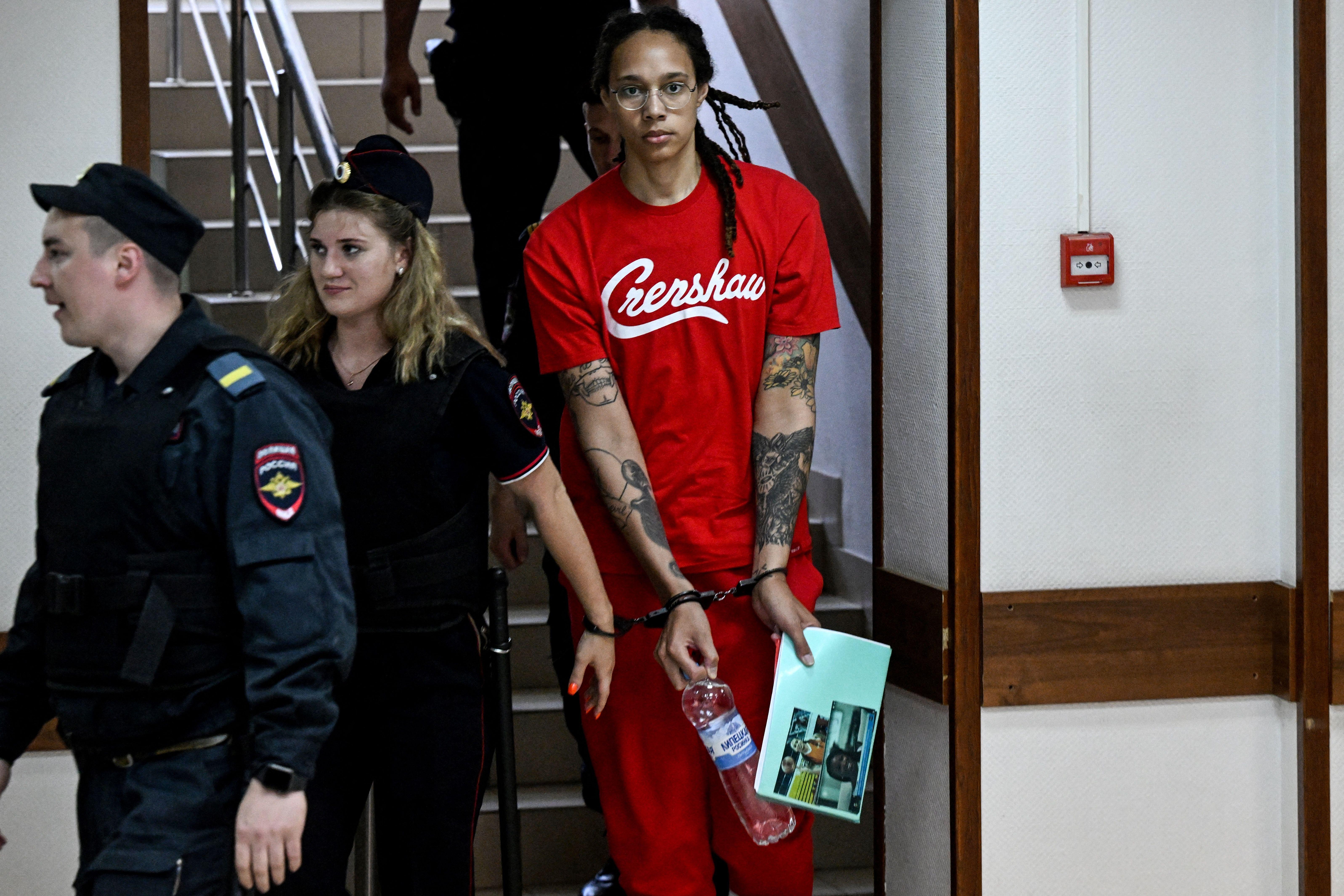 Griner is seen in a "Crenshaw" tee-shirt and handcuffs.