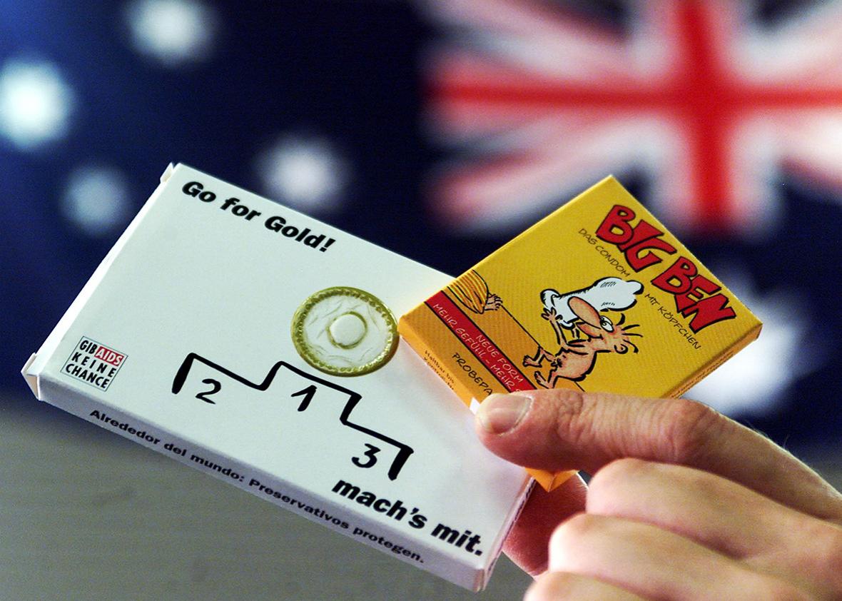 Picture shows a package of condoms written "Go for Gold - do it with" in front of an Australian flag during  equipment check of the German Olympic team in Mainz, August 9, 2000. 
