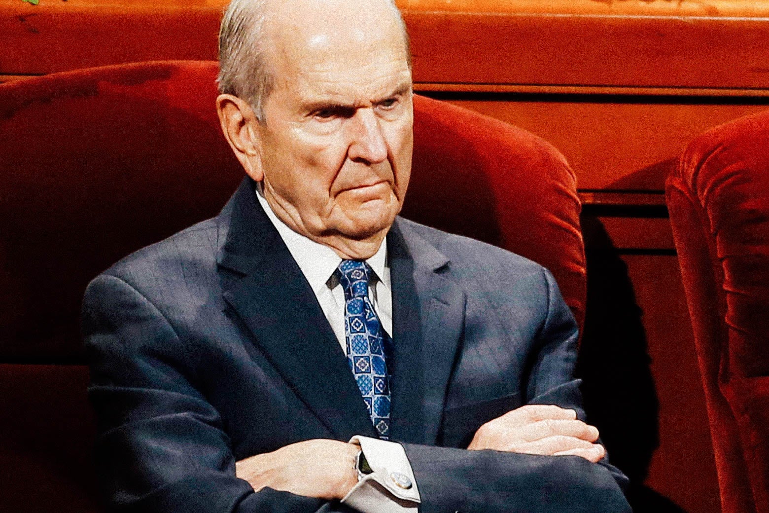 Russell Nelson seated, with his arms crossed.
