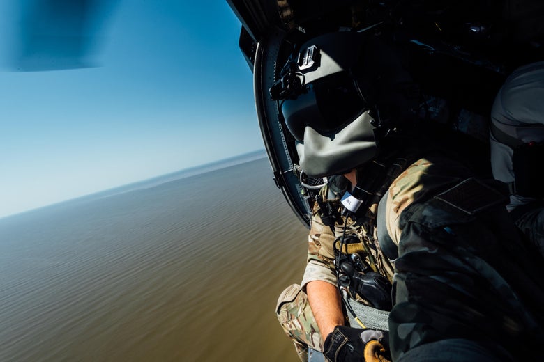 TEXAS - AUGUST 31: In this U.S. Air Force handout, Senior Airman Austin Hellweg, 129th Rescue Squadron special missions aviator, looks out the side door of a HH-60 Pavehawk on the way to aide in the relief effort for Hurricane Harvey, Aug. 31st, 2017, over Texas. The relief efforts have a conglomerate of active, guard and reserve units from all branches aiding the federal government to help Texas recover from Hurricane Harvey. (Photo by Staff Sgt. Jordan Castelan/U.S. Air Force via Getty Images)