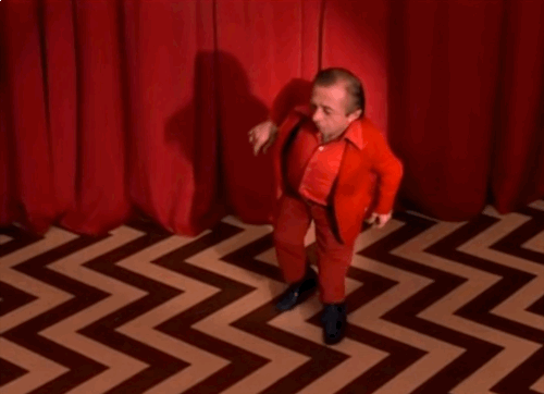 Dwarf dancing on red chevron floor in Twin Peaks.