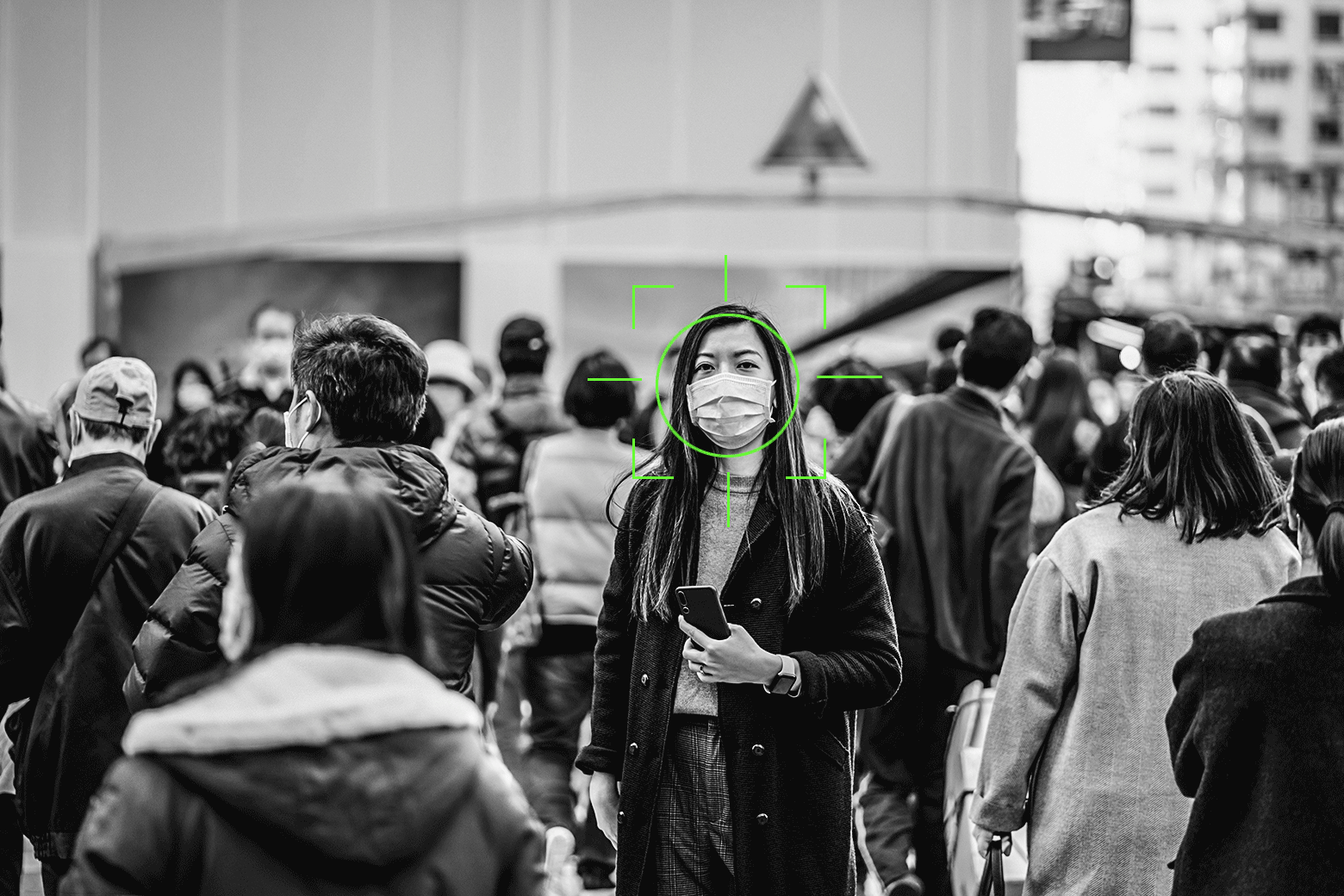 An animation of facial recognition marks zeroing in on a woman in a crowd and then linking to a mouth talking, floating above her