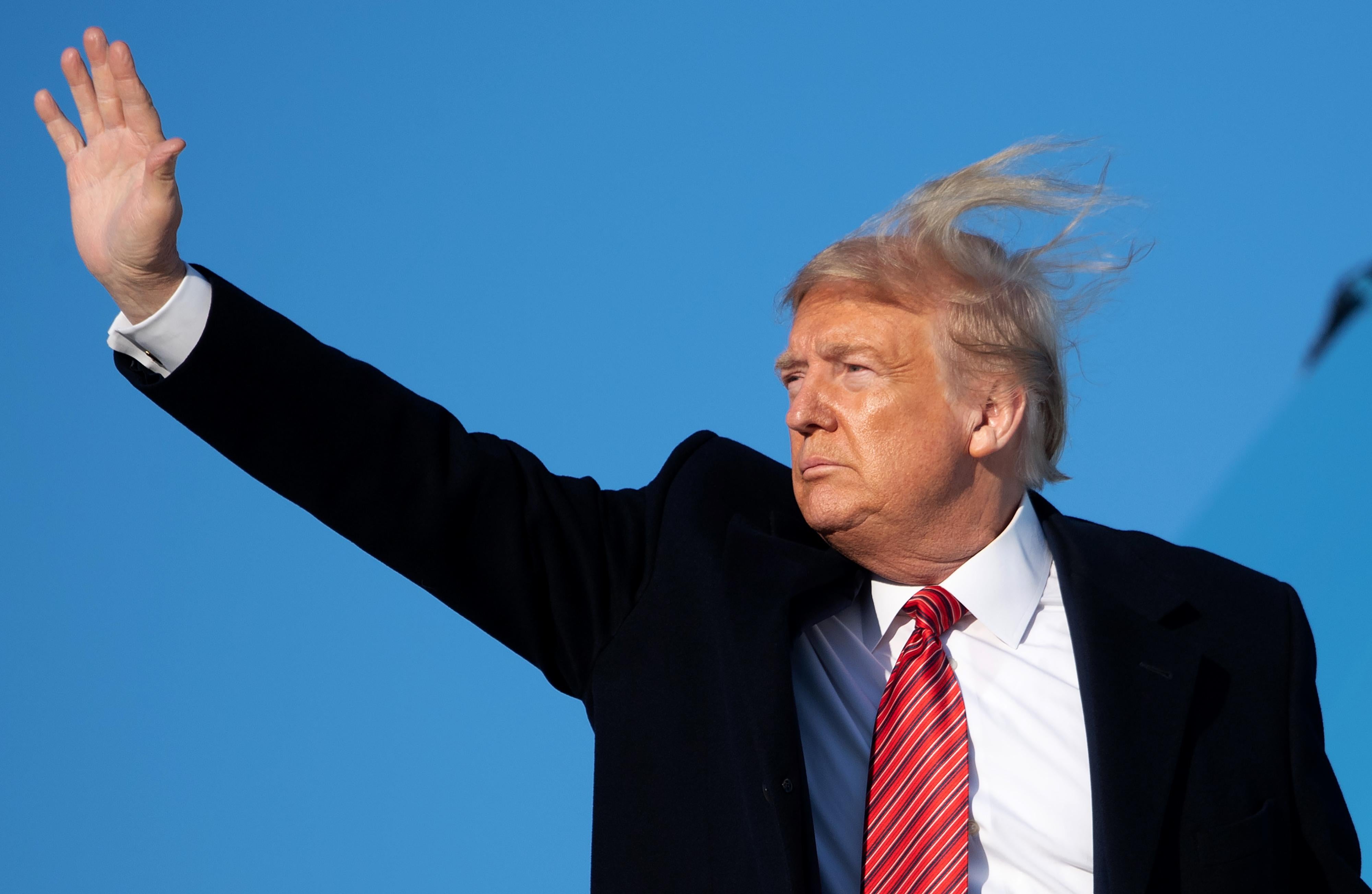 Trump's hair, such as it is, blowing wildly out of control in the wind.