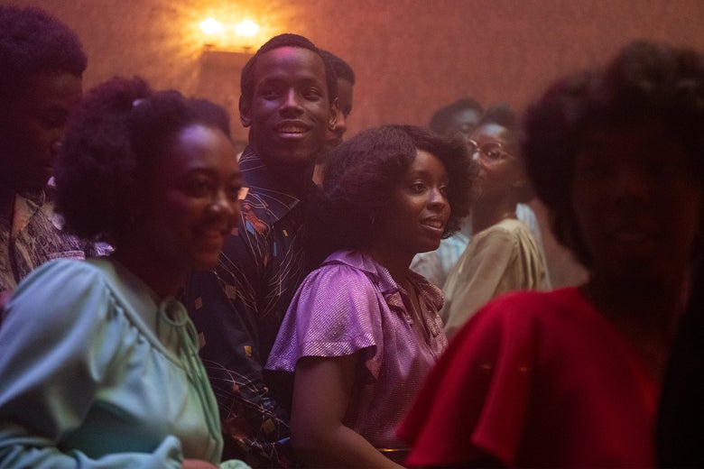 A young Black man and woman dancing happily at a house party in 1980 London.
