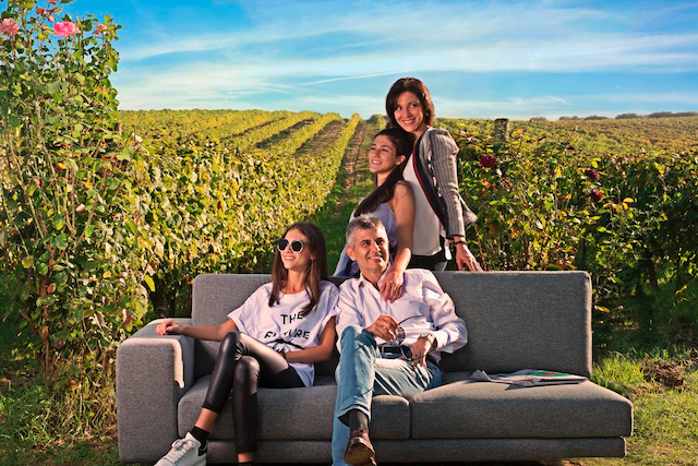 Piero Mastroberardino sitting with family in vineyard.