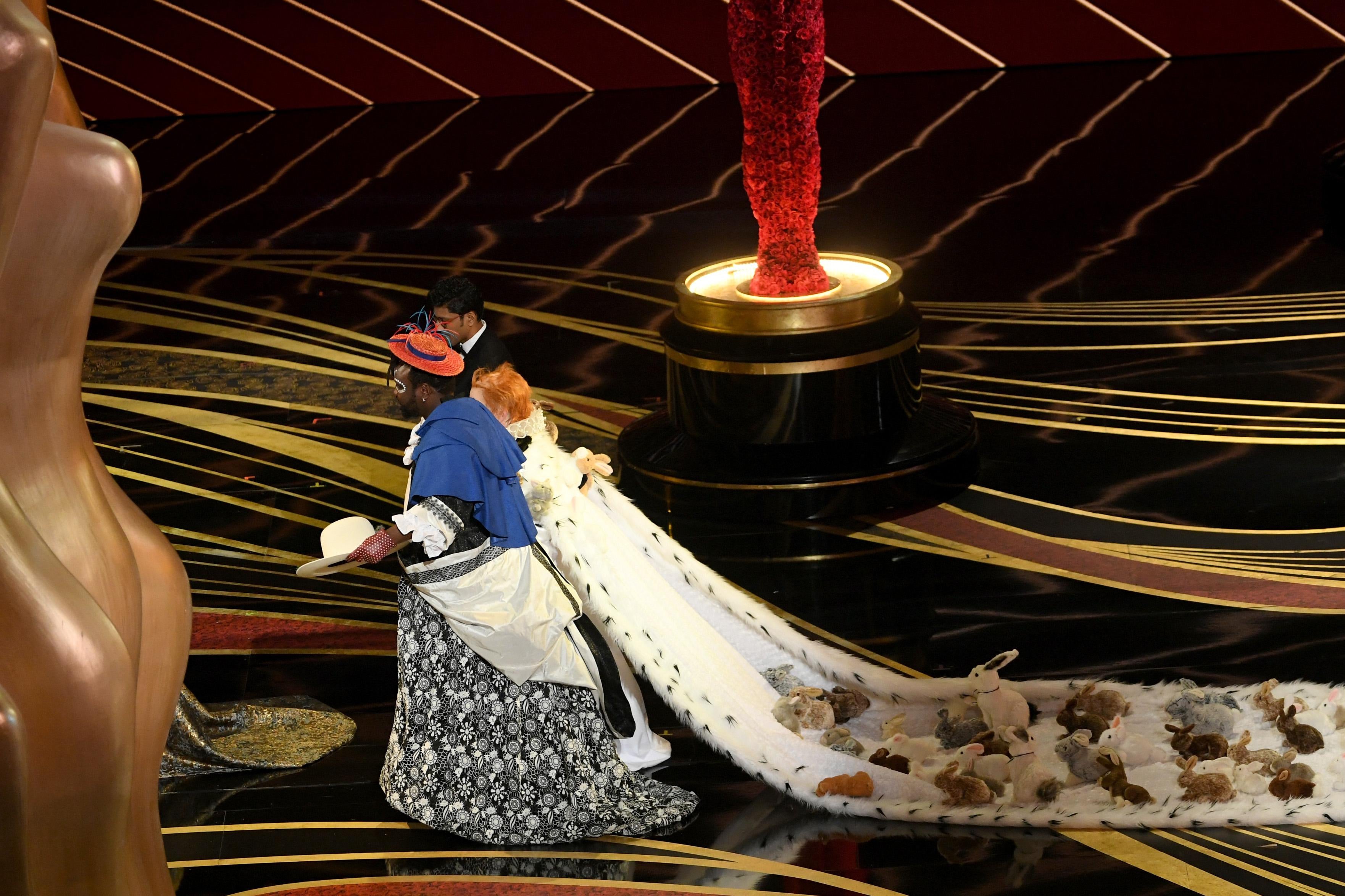 Melissa McCarthy is trailed by an enormous train covered in rabbits.