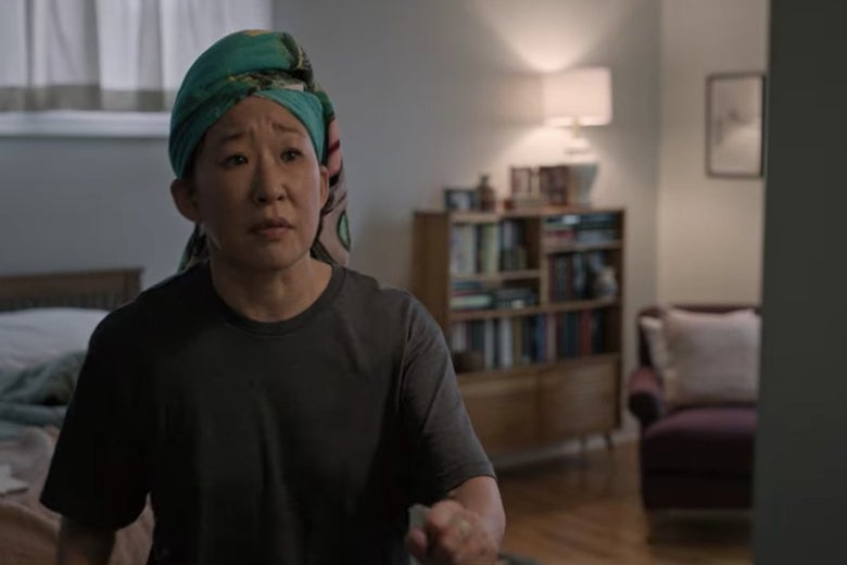 Dr. Kim with her hair wrapped in a towel, sitting on her bed.