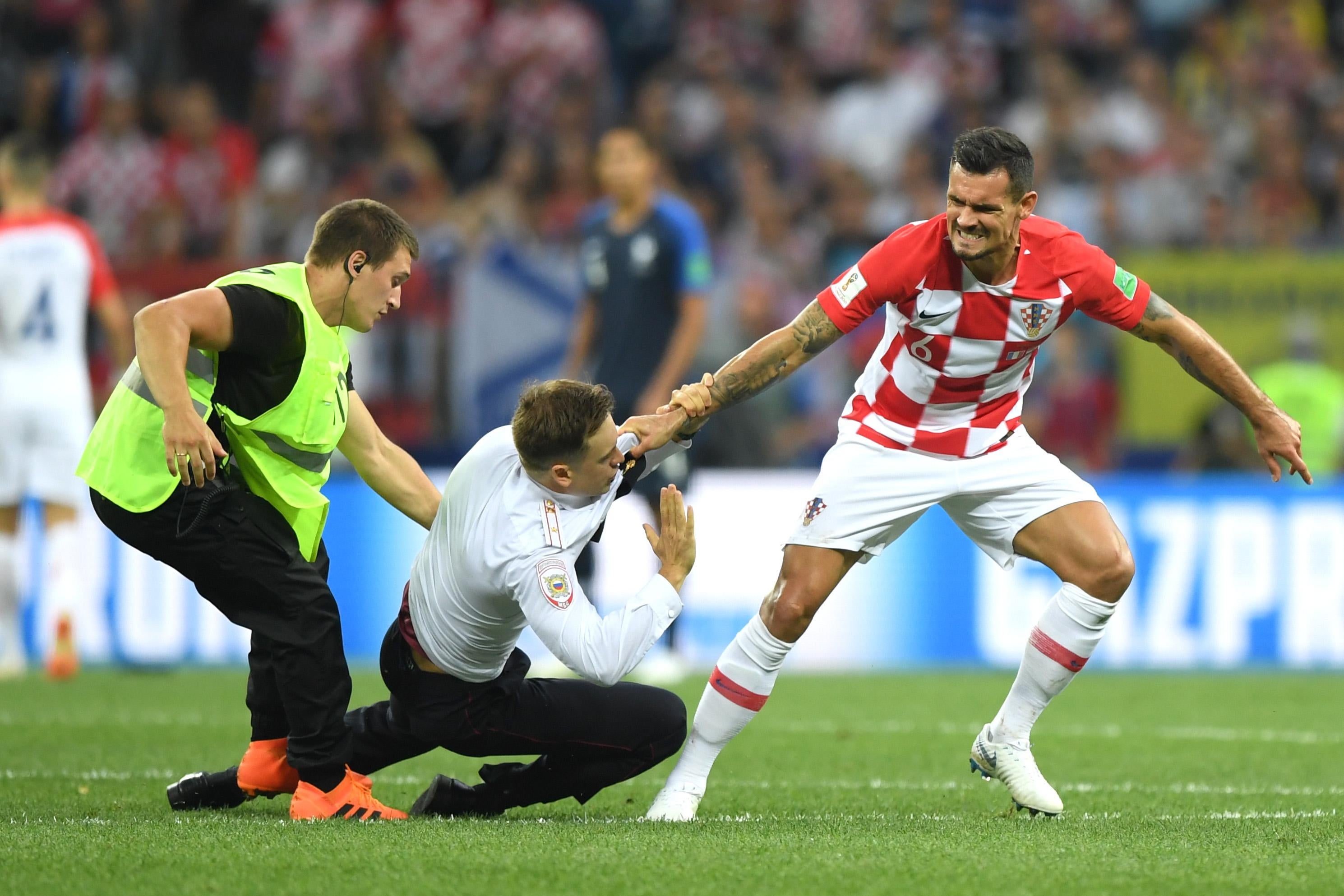 MOSCOW, RUSSIA - JULY 15:  Dejan Lovren of Croatia confronts a pitch invader during the 2018 FIFA World Cup Final between France and Croatia at Luzhniki Stadium on July 15, 2018 in Moscow, Russia.  (Photo by Shaun Botterill/Getty Images)