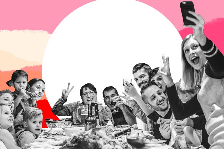 Multi-generations of a family gathered around a Thanksgiving table to take a selfie.