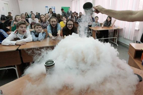 Pupils watch the effect produced by liquid nitrogen during a demonstration at a local grammar school in Russia's Siberian city of Krasnoyarsk, Russia on November 21, 2012.