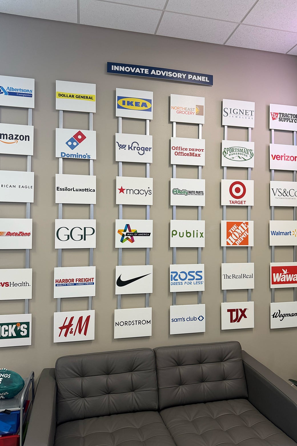 A list of corporate logos on a wall.