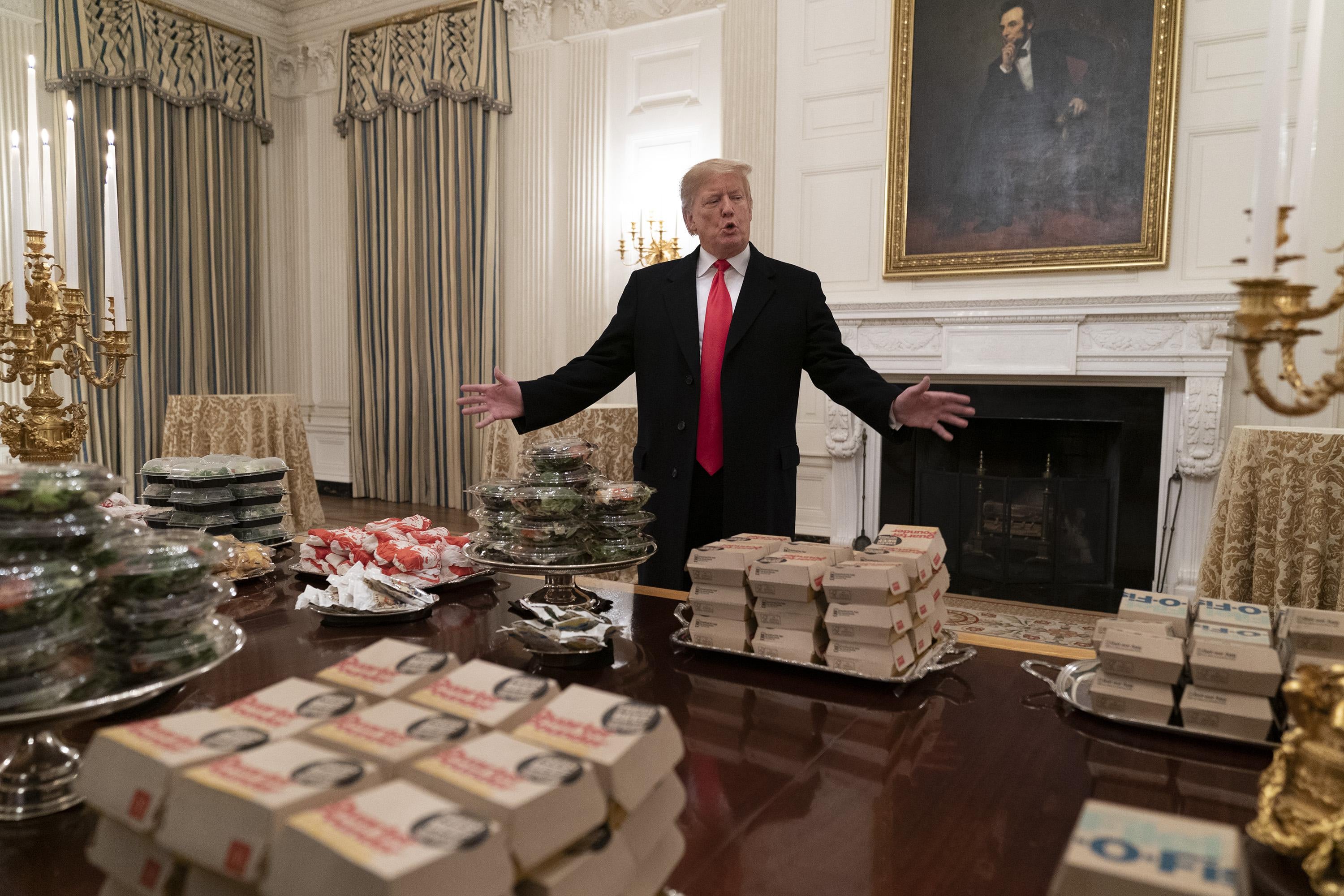 President Trump presents a table full of fast food.